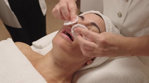 Woman Receiving Facial Treatment With Cotton Pads