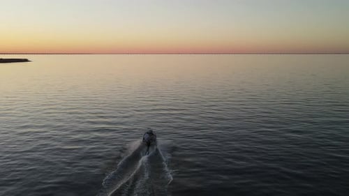 Boat on Calm Water at Sunrise or Sunset