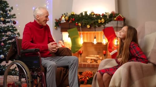 Grandfather and Granddaughter by the Christmas Tree