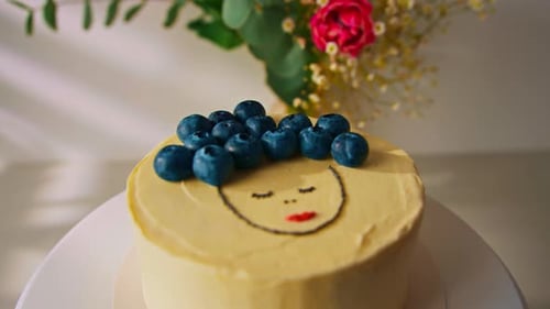 delicious freshly made sponge cake bento decorated with blueberries cake on a stand on a white