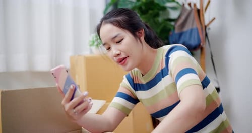 Young Woman Recording Video of Products at Home