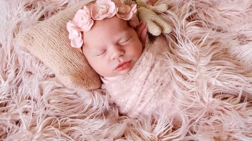 Sleeping Newborn with Flower Crown in Gentle Light