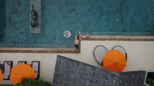Luxury Tourists Relax By Swimming Pool During Tropical Vacation Couple Enjoys Floating Breakfast at