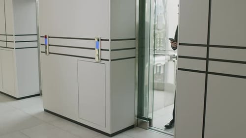 Male Executive Coming off Office Elevator