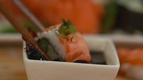 Closeup Dipping Sushi Into Soy Sauce in Super