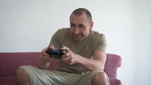 Man Playing Video Games on Sofa