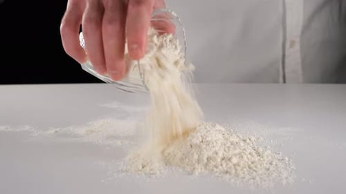 Pouring Flour on the White Table
