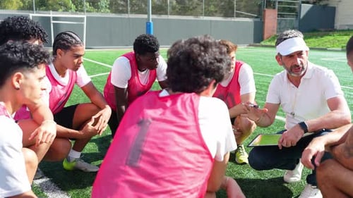 Soccer Team Huddles With Coach On Field