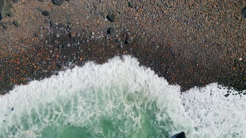 Aerial View Beautiful Waves Rolling on Seashore with Dark Stones Ocean Foaming