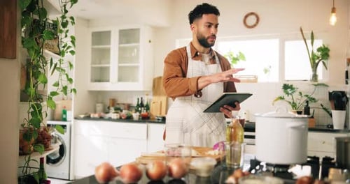 Man Uses Tablet for Recipe in Bright Kitchen