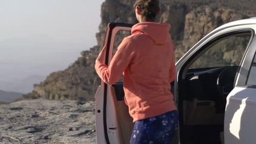 Young Woman Walking Out of Car and Admire Canyon View, Super Slow