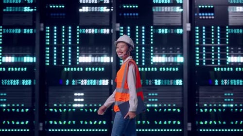 Asian Female Holding Tablet While Walking in Data Center