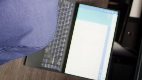 Adult Working at Desk with Laptop