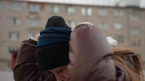 Woman Smoothing Her Beanie in Brisk City Breeze Closeup Shot of Lady Adjusting Her Hat Amidst Cold