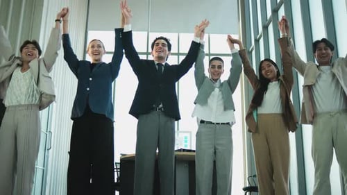 Diverse Business Team Holding Hands in an Office