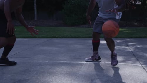 One on One Street Basketball; Closeup on Feet of Player Dribbling And