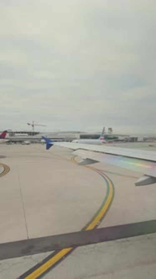 Vertical Shot of AirPlane Drive on Runway in Chicago Airport Wide View