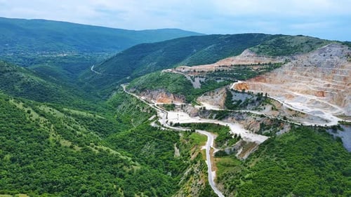 Natural Quarry is Located Near Road Against Backdrop of Rhodope Mountains and Hills with Forests and