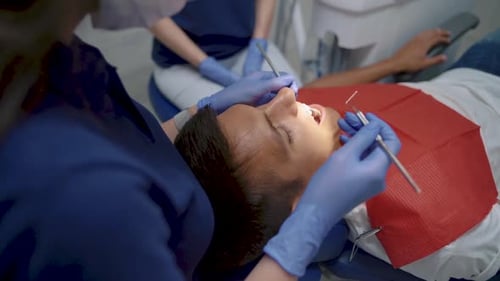 Dentistry concept. Patient sitting on dental chair in paediatric dentists office