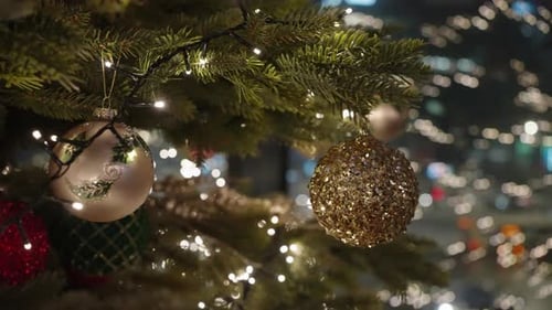 Decorated Christmas Tree Over Blurred Night City Lights at the Celebration Party