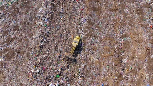 Aerial View of Bulldozer in Vast Landfill
