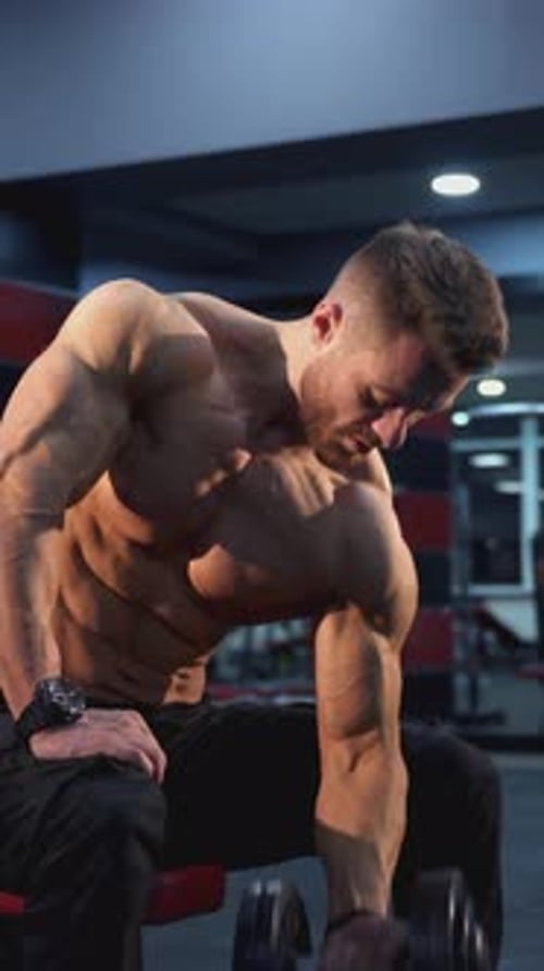 Man Lifting Weights in Gym Biceps Workout