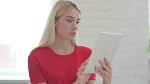 Young Woman Using Tablet for Video Chat