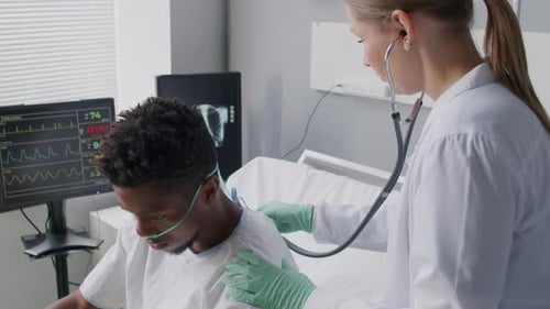 Doctor Checking Patient with Stethoscope in Hospital Ward