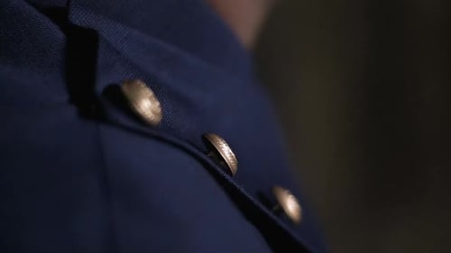 Indian groom close-up of blue suit with gold buttons in slow-motion elegance