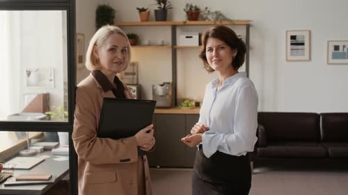 Portrait of Two Confident Middle-Aged Businesswomen in Modern Office
