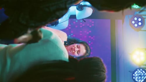 Female Singer Performing on Stage with Colorful Lights