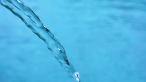 Water Stream Flowing Into Blue Swimming Pool