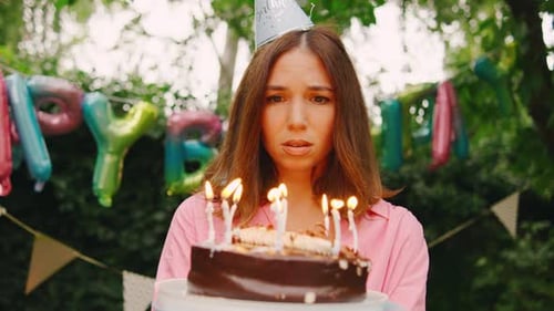 Woman Looks Sad Holding Birthday Cake With Candles