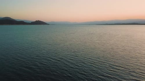 Aerial drone flying over a lake, water dam, with mountains at sunrise. Beautifull dreamy landscape v