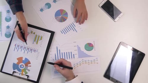 Team Strategy Session Analyzing Market Data and Financial Performance Charts