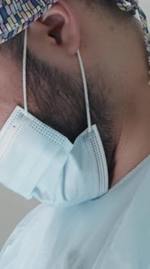 Caucasian Male Healthcare Professional in a Hospital Operating Theatre Wearing a Surgical Cap and