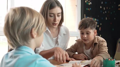Children Learn with Teacher in Classroom Setting