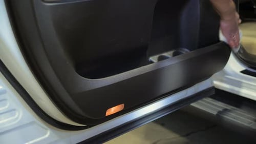 Man Cleaning Car Interior Door with Cloth