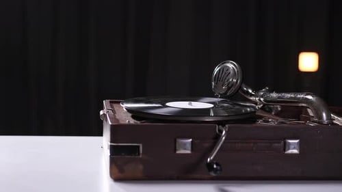 Hand Places Stylus on Vintage Record Player