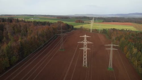 Large transmission towers in countryside. Tall electricity pylons with steel wires