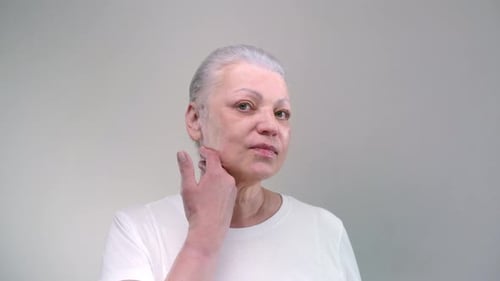Woman Massaging Face and Neck for Skincare