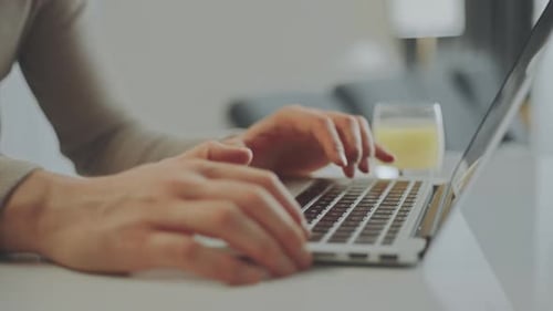 Hands Typing on Laptop Keyboard Close Up
