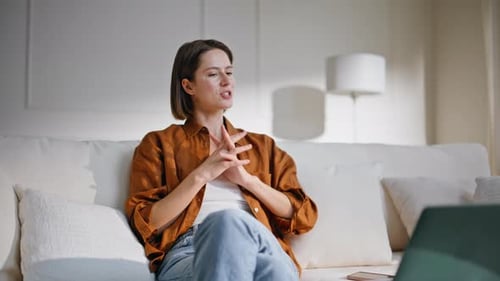 Woman Talking on Video Call on White Couch