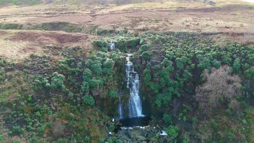 Aerial drone footage of a tall rocky waterfall in the Yorkshire Dales, Pennies. Moorland scene of a