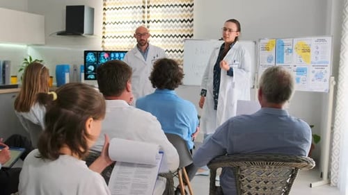Medical Professionals Delivering Presentation to a Group of People