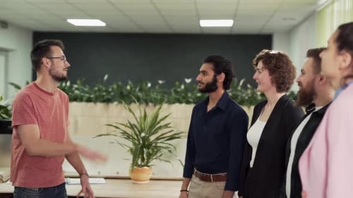 A young office worker gives five colleagues a job