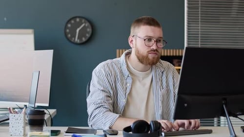 Young Caucasian Man Working On Computer In Office