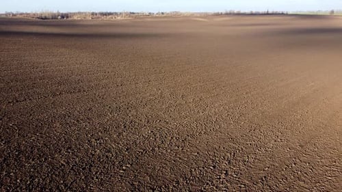 Landschaft von gepflügtem Land auf einem landwirtschaftlichen Feld an einem sonnigen Herbsttag