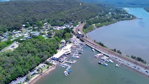 Drone aerial landscape of Brooklyn rural town suburbs surrounded by bushland forest with wharf pier