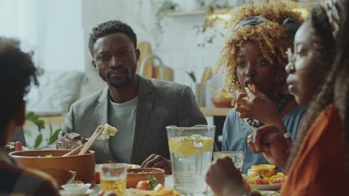 Family and Friends Enjoy Meal Together at Home